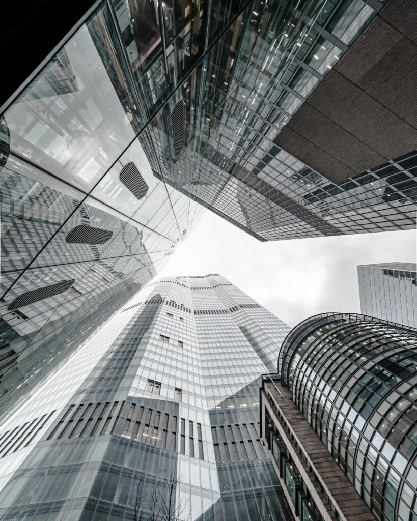 Vertical low angle shot of a modern business building scenery touching the sky